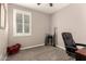 Office space with a modern desk chair and a window with white shutters providing natural light at 41342 W Elm Dr, Maricopa, AZ 85138