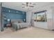 Calm bedroom featuring a navy accent wall, and a large window with ample natural light at 4273 S Red Rock St, Gilbert, AZ 85297