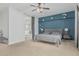 Stylish bedroom featuring a navy accent wall, and an ensuite bath with natural light at 4273 S Red Rock St, Gilbert, AZ 85297