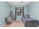 Charming bedroom featuring a single bed, patterned chair, and soft, natural light at 4273 S Red Rock St, Gilbert, AZ 85297