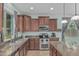 Modern kitchen with stainless steel appliances, granite countertops, and ample cabinet space for storage at 4273 S Red Rock St, Gilbert, AZ 85297