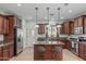 Well-lit kitchen with granite countertops, stainless steel appliances, and a center island with seating at 4273 S Red Rock St, Gilbert, AZ 85297