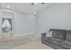 Bright living room with gray sofa, patterned rug, and open view to another room at 4273 S Red Rock St, Gilbert, AZ 85297