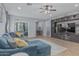 Bright living room featuring a comfortable blue sectional sofa, entertainment center, and neutral color palette at 4273 S Red Rock St, Gilbert, AZ 85297