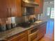 Modern kitchen features stainless steel appliances, granite countertops, and stylish wood cabinetry at 514 W Monte Vista Rd, Phoenix, AZ 85003