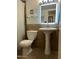 Bathroom featuring a pedestal sink with an illuminated mirror, plus a toilet, and a shower curtain at 5212 N 42Nd Ln, Phoenix, AZ 85019