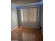 Bedroom with wood floors and vertical blinds, presenting a simple, clean space at 5212 N 42Nd Ln, Phoenix, AZ 85019