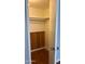 View into a closet with wooden paneling, shelves, and hanging rod, ready for organization at 5212 N 42Nd Ln, Phoenix, AZ 85019