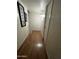 Hallway with wood floors, white doors and a stylish picture gallery at 5212 N 42Nd Ln, Phoenix, AZ 85019