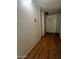 Hallway with wood floors, white doors and simple lighting at 5212 N 42Nd Ln, Phoenix, AZ 85019