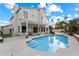 Expansive backyard featuring a swimming pool, basketball court, and mature palms at 5402 E Helena Dr, Scottsdale, AZ 85254