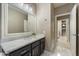 Well-lit bathroom with modern vanity, marble countertops, and a large mirror at 5402 E Helena Dr, Scottsdale, AZ 85254