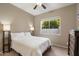 Simple bedroom with a queen-sized bed, neutral walls, and a view to the back yard at 5402 E Helena Dr, Scottsdale, AZ 85254