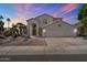 Charming two-story home featuring a 3-car garage, desert landscaping, and a welcoming front entrance at 5402 E Helena Dr, Scottsdale, AZ 85254