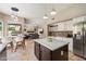 Open kitchen design with a marble-top island, stainless steel appliances, and seamless flow into the living and dining areas at 5402 E Helena Dr, Scottsdale, AZ 85254