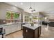 Bright kitchen island with marble countertops and views of pool, blending indoor and outdoor living in a functional layout at 5402 E Helena Dr, Scottsdale, AZ 85254