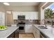 Well-lit kitchen features white cabinets, stainless steel appliances, and sleek countertops, offering a modern and functional space at 5402 E Helena Dr, Scottsdale, AZ 85254