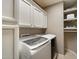 Convenient laundry room featuring front-load washer and dryer and ample storage at 5402 E Helena Dr, Scottsdale, AZ 85254