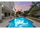 Sparkling swimming pool with a covered patio, outdoor seating, and lush tropical landscaping at 5402 E Helena Dr, Scottsdale, AZ 85254