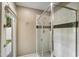 Clean, modern bathroom shower with glass doors, tile surround, and a view to the patio at 5402 E Helena Dr, Scottsdale, AZ 85254