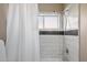 Modern tiled shower with a rainfall showerhead and sleek fixtures at 5402 E Helena Dr, Scottsdale, AZ 85254