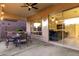 Covered patio with outdoor seating area and view of the living room through large sliding glass doors at 5424 N 186Th Dr, Litchfield Park, AZ 85340