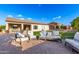 Spacious backyard features lounge furniture on a brick patio, a grassy area, and an inviting swimming pool at 5424 N 186Th Dr, Litchfield Park, AZ 85340