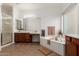 A bright bathroom featuring double sinks, a soaking tub, and a separate shower, offering a spa-like experience at 5424 N 186Th Dr, Litchfield Park, AZ 85340