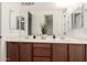 Bathroom featuring double sinks, large mirror, and natural lighting at 5424 N 186Th Dr, Litchfield Park, AZ 85340