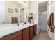 Well-lit bathroom features a long vanity with double sinks, a mirror, and a separate toilet and shower area at 5424 N 186Th Dr, Litchfield Park, AZ 85340