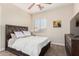 Cozy bedroom with large bed, ceiling fan and bright window at 5424 N 186Th Dr, Litchfield Park, AZ 85340