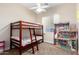 Bright bedroom featuring bunk beds and a large dollhouse at 5424 N 186Th Dr, Litchfield Park, AZ 85340