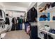 Well-organized walk-in closet with shelving and rods to maximize storage space for clothing and accessories at 5424 N 186Th Dr, Litchfield Park, AZ 85340