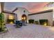 Charming courtyard view with brick pavers, inviting seating, and warm lighting at 5424 N 186Th Dr, Litchfield Park, AZ 85340