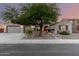 Inviting single-Gathering home featuring a well-maintained yard, brick accents, and a spacious three-car garage at 5424 N 186Th Dr, Litchfield Park, AZ 85340