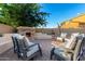 Backyard patio with outdoor fireplace feature and cozy seating area at 5424 N 186Th Dr, Litchfield Park, AZ 85340