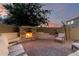 Inviting backyard stone fireplace and comfortable seating area perfect for cool evenings and outdoor gatherings at 5424 N 186Th Dr, Litchfield Park, AZ 85340