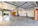 Spacious three-car garage featuring an automobile lift and built-in storage cabinets at 5424 N 186Th Dr, Litchfield Park, AZ 85340