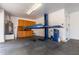 Spacious garage with a vehicle lift, water heater, storage cabinets, and a utility sink at 5424 N 186Th Dr, Litchfield Park, AZ 85340