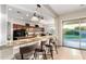 Open-concept kitchen with granite countertops, a breakfast bar, and a view of the inviting backyard at 5424 N 186Th Dr, Litchfield Park, AZ 85340
