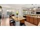 Bright kitchen featuring a central island with seating, granite countertops, stainless steel appliances, and a breakfast nook at 5424 N 186Th Dr, Litchfield Park, AZ 85340