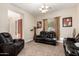 Cozy living room furnished with plush leather recliners, creating a comfortable and inviting space for relaxation and entertainment at 5424 N 186Th Dr, Litchfield Park, AZ 85340