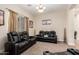 Inviting living room with modern recliners, neutral carpet and large window at 5424 N 186Th Dr, Litchfield Park, AZ 85340