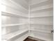 Spacious walk-in pantry with ample shelving for organized storage, maximizing space and functionality at 5424 N 186Th Dr, Litchfield Park, AZ 85340