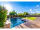 Beautiful backyard pool with well-maintained lawn, mature trees and pool-side lounge chairs at 5424 N 186Th Dr, Litchfield Park, AZ 85340