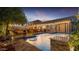 Tranquil backyard pool with seating and overhead string lights, perfect for evening relaxation and entertaining at 5424 N 186Th Dr, Litchfield Park, AZ 85340