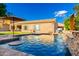 Backyard oasis with a pool, a water feature, and lush greenery at 5424 N 186Th Dr, Litchfield Park, AZ 85340