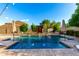 Private swimming pool with fountains and umbrellas, set amongst lush, mature landscaping at 5424 N 186Th Dr, Litchfield Park, AZ 85340