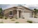 Inviting single-story home featuring a neutral color scheme, a two-car garage, and manicured landscaping at 5511 W Piedmont Rd, Laveen, AZ 85339