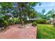 Spacious backyard with well-maintained grass, a fountain feature, mature trees, and ample greenery at 5536 N Camelback Canyon Pl, Phoenix, AZ 85018